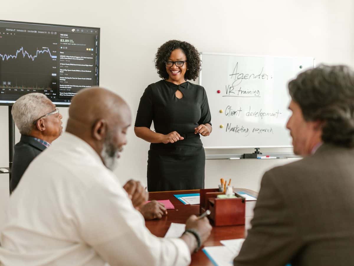 A nonprofit leader presenting to board members around a conference table