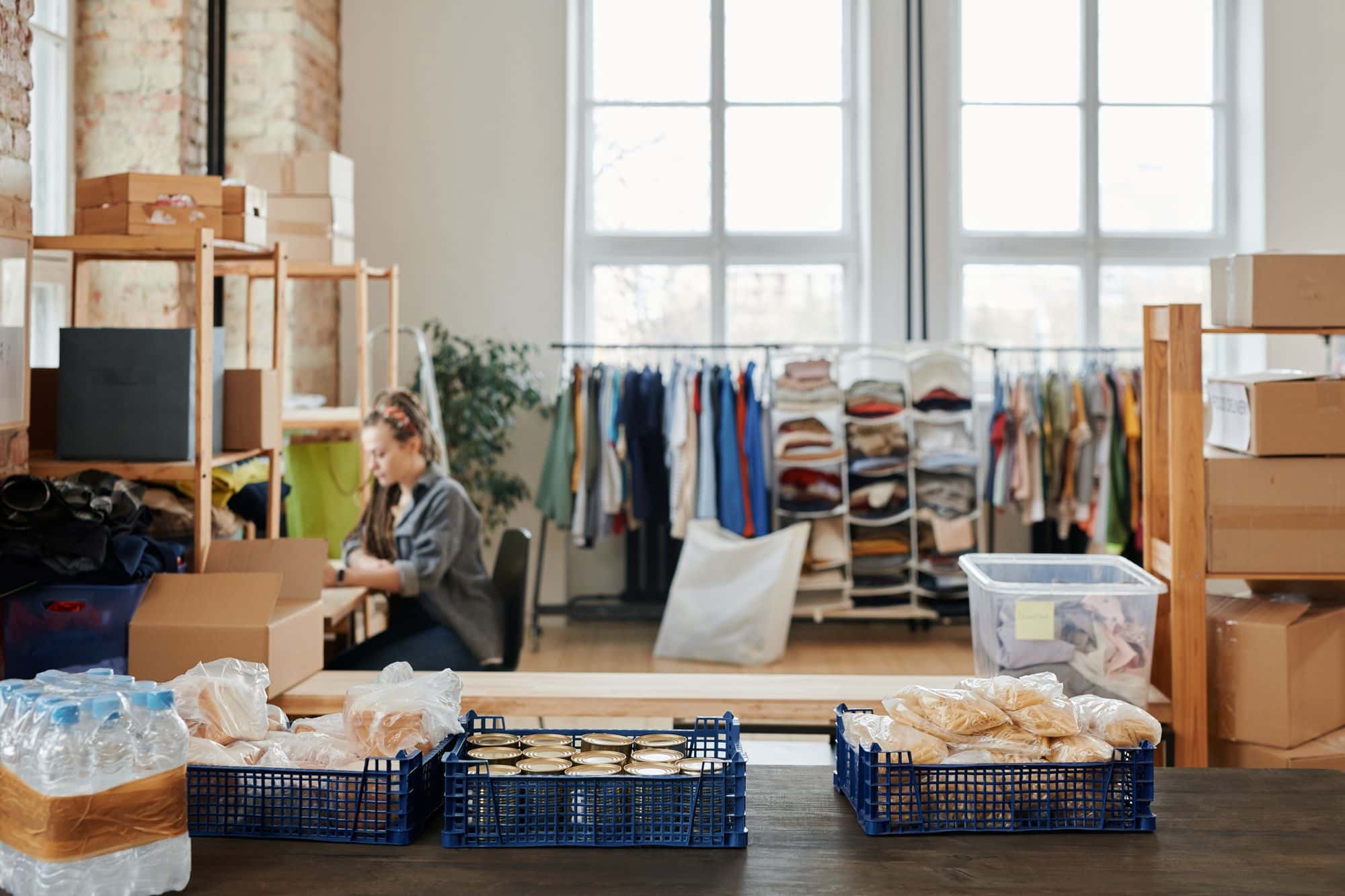 Food and clothing donations sorted at a community service center