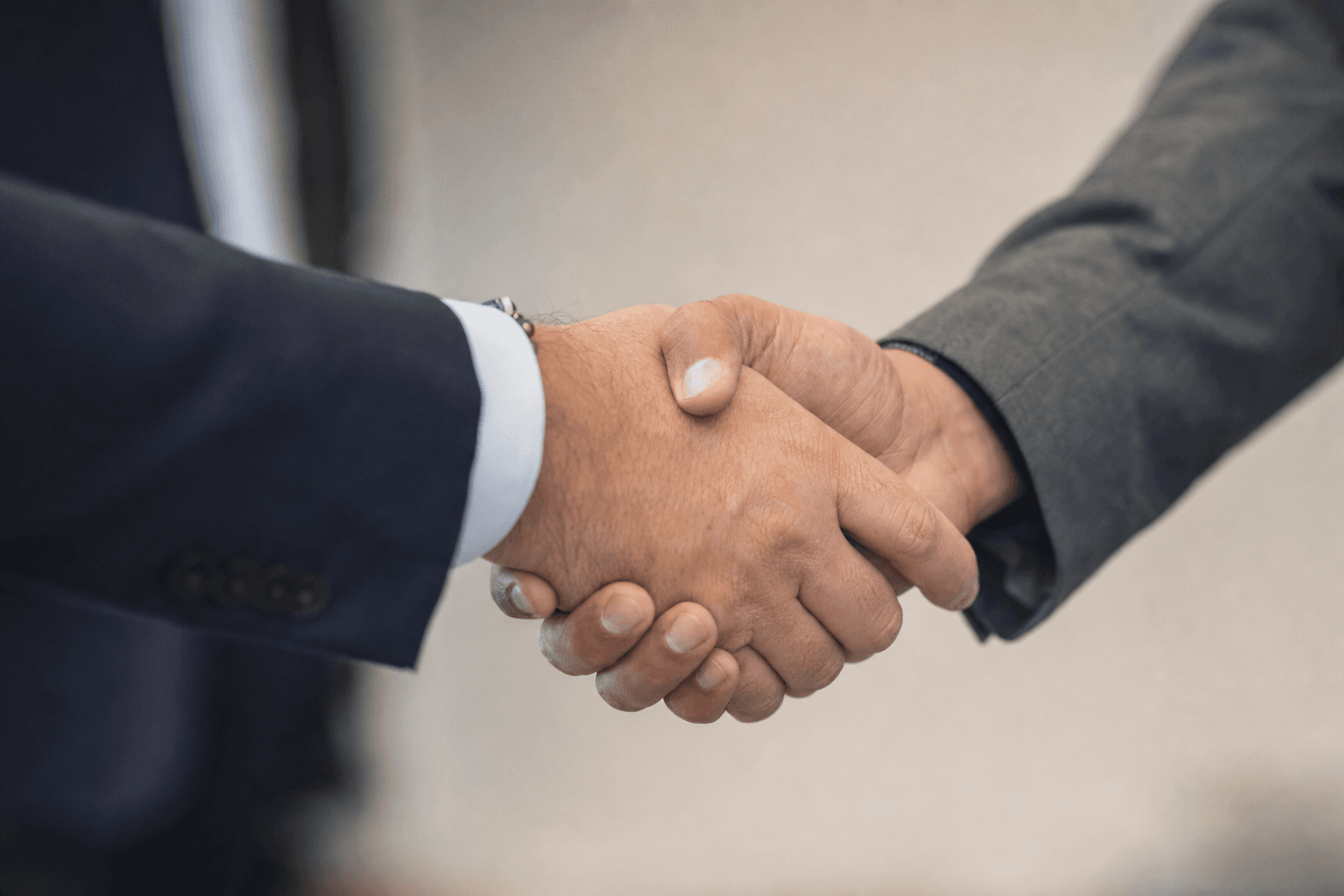 Two consultants shaking hands, symbolizing a trusted long-term fundraising consulting partnership