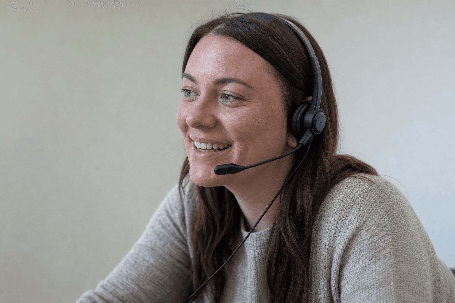 A fundraising engagement officer smiling while making a personalized phone call